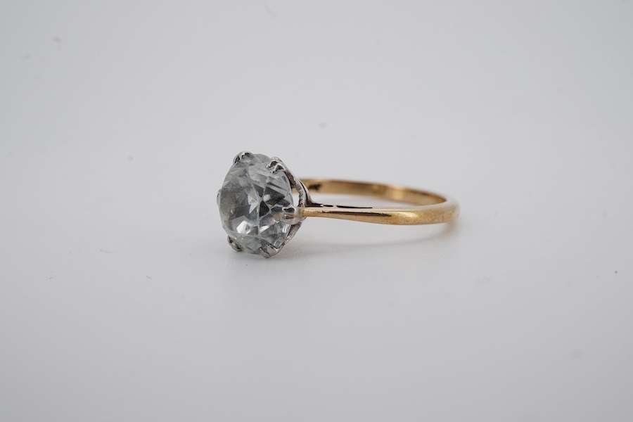 A yellow metal (stamped '9ct sil') and single stone white zircon set ring, gross weight 2.9 grams. Condition - poor to fair